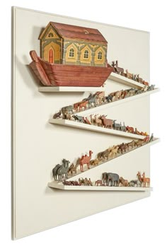 three wooden shelves with animals on them and a small house in the middle one shelf is made out of plywood