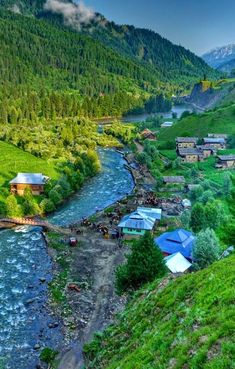 a river running through a lush green hillside