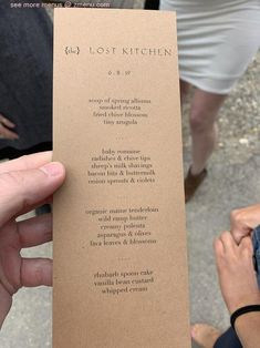 a person holding up a piece of paper with the words lost kitchen written on it