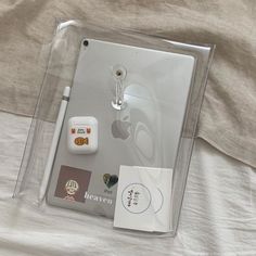 an apple product in its plastic package on a bed with the packaging attached to it