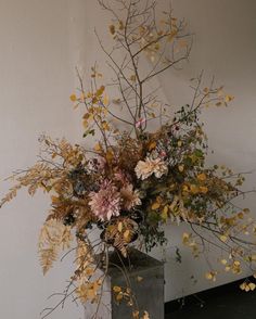 a vase filled with lots of different types of flowers