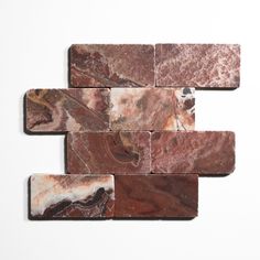 some brown and white marble tiles on a white surface