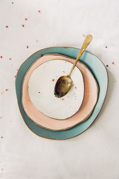 a spoon sitting on top of a plate with confetti sprinkles