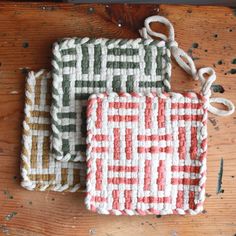 three woven bags sitting on top of a wooden table