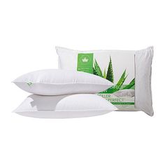 two pillows on top of each other and one pillow with an aloem print