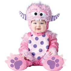 a baby wearing a pink and purple monster costume