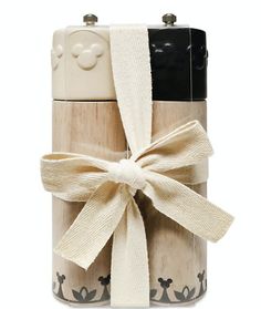 a mickey mouse lighter with a bow tied around it's neck and the lid