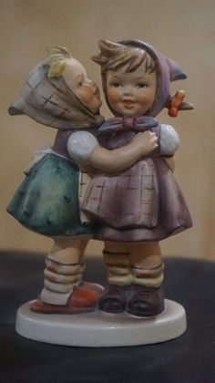 a figurine of two children hugging each other