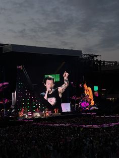 an image of a concert being performed on the stage with people in the audience watching