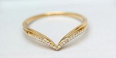 a gold ring with white diamonds on it