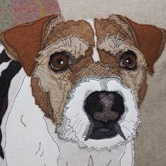 a close up of a dog's face on a piece of fabric with a zebra print background