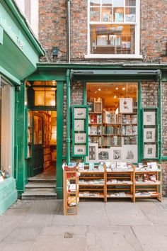 the outside of a book store with tables and chairs