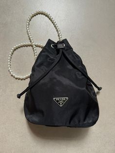 - Brand : Prada  - Luxury brand items - Authentic Prada Red  Nylon Tessuto Small Bucket Drawstring Bag Black - Silver-tone hardware - Made in Italy - Size: W 16.5 cm x H 21.5 cm x D 10 cm - Come with a chain strap, not original Prada's chain strap ( for variety of use) - Overall in very good condition - With our own store packing will be included - Guaranteed 100% authentic - Free Shipping - We shipped worldwide! {Gentle Reminder} - Vintage Luxury Brand Store from Hong Kong - Pre-loved vintage item, might have imperfections. Colors may differ slightly from actual product appearance due to differences in lighting conditions. - Buyer are fully responsible for customs duties, other local taxes and any administrative procedures related to imports into the country of destination. - Feel free to Luxury Brand Store, Prada Nylon Bag, Prada Hobo, Prada Mini, Prada Red, Bag Prada, Small Buckets, Prada Nylon, Brand Store