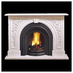 a white fireplace with an ornate design and fire in the center, on a black background