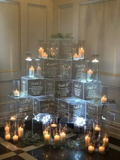 a table topped with lots of lit candles