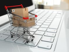 a shopping cart sitting on top of a laptop keyboard