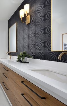 a modern bathroom with black and white wallpaper, wooden cabinets and large mirror above the sink