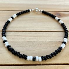 The Black & White beaded anklet can go with any outfit. Whether you are out at dinner or a party on the beach, this anklet is just what you need! All anklets are customizable to the size you need so please be sure to measure your ankle where you want your anklet to sit and order accordingly! This high quality beaded anklet is secured with a sterling silver lobster claw and made with glass beads that can stand the test of time, making it perfect for everyday use. Keep in mind you are looking Beads Bracelet Design Black, Black And White Seed Bead Bracelet, Beaded Black Bracelets, Black And White Bead Bracelet, Black And White Beads Bracelet, Black Bead Bracelet Ideas, Bead Anklet Ideas, Anklet Designs Beads, Black Bracelet Ideas