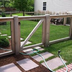 a fenced in yard with a hose attached to it