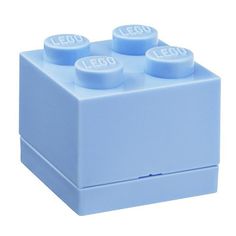 a light blue lego brick with four small round knobs on the front and two smaller round knobs on the back