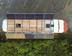 an aerial view of a small house in the woods