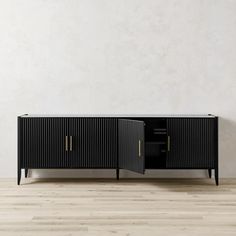 the sideboard is black and has two doors on each side, with gold handles