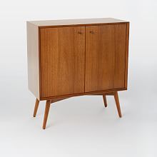 a wooden cabinet with two doors and legs