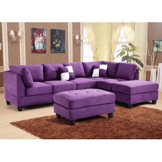 a purple couch and ottoman in a living room