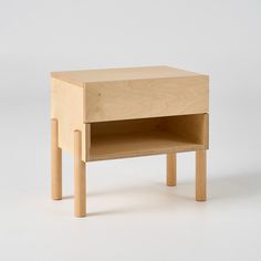 a small wooden table sitting on top of a white floor