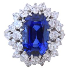 This is a beautiful and important Boucheron sapphire ring with a natural non-heated Royal Blue Burma sapphire of 7.70 carats (with SSEF certificate), surrounded by marquise cut diamonds of circa 4 carats. The sapphire is of gem quality and exhibits a very fine crystal with no visible inclusions. The ring is signed by Boucheron and has its makers' marks. Ring size 5-1/2. Boucheron Jewelry, Blue Sapphire Jewelry, Diamonds Rings, Vintage Cocktail Ring, Bracelets Design, Diamond Cocktail Rings, Sapphire Diamond Ring, Vintage Cocktail, Bling Rings