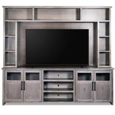 an entertainment center with a flat screen tv on it's side and shelves below