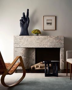 a living room filled with furniture and a fire place covered in art deco style artwork