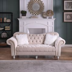 a living room with a couch, fireplace and mirror on the wall in it's corner