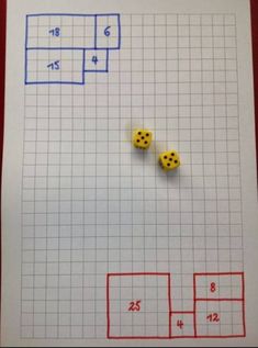 two yellow dices sitting on top of a piece of paper with numbers and squares