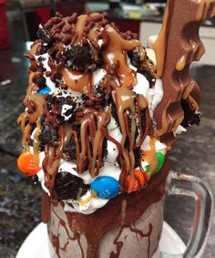 an ice cream sundae with chocolate and candy toppings