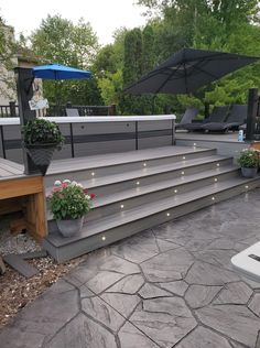 an outdoor patio with steps and potted plants