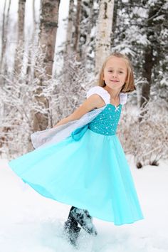 "PRACTICAL PRINCESS ELSA DRESS This is a fun new PRACTICAL PRINCESS dress for your little girl. This dress has a sweetheart neckline, with , cute gathered strap sleeves and circle skirt. The back has elastic and a waist tie for a fit that is comfortable to wear as well as cute. The dress has a white cape with metallic silver sparkles sewn onto the dress. The dress is made with a cotton/poly blend that is cool and easy to wear:) The sparkle cape fabric is printed with a glitter design. The top is Frozen Halloween Costumes, Princess Elsa Dress, Toddler Princess Dress, Anna Costume, Frozen Elsa Dress, Costume Princess, Frozen Dress, Elsa Costume, Frozen Costume