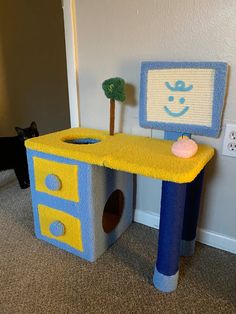 a cat house made to look like a computer desk