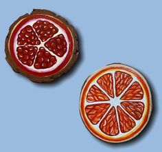 two pieces of fruit cut in half on a blue background