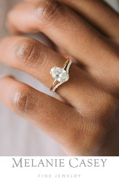 a woman's hand with a diamond ring on her finger and the words melanie casey fine jewelry