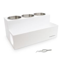 a white box with three silver bowls in it and a pair of scissors next to it