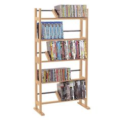 a wooden book shelf filled with lots of books and video game equipment on top of it