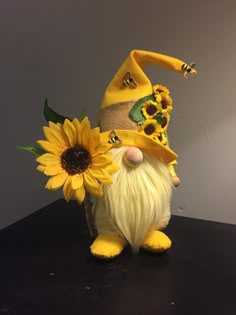 a yellow gnome figurine with sunflowers on top