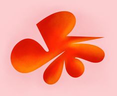 an orange object on a pink background that appears to be shaped like a flower or leaf