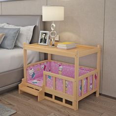 a bed with a wooden frame and pink bedspread next to a night stand