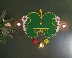 a decorated rangolite with candles on the floor in front of plants and potted plant