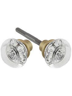 pair of crystal glass door knobs with brass finish and screwdriver on white background