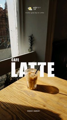 a table with a drink on it and the words cafe latte