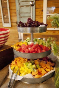 three tiered trays filled with different types of fruit