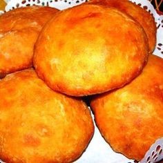 some food that is sitting in a bowl on a table with white doilys